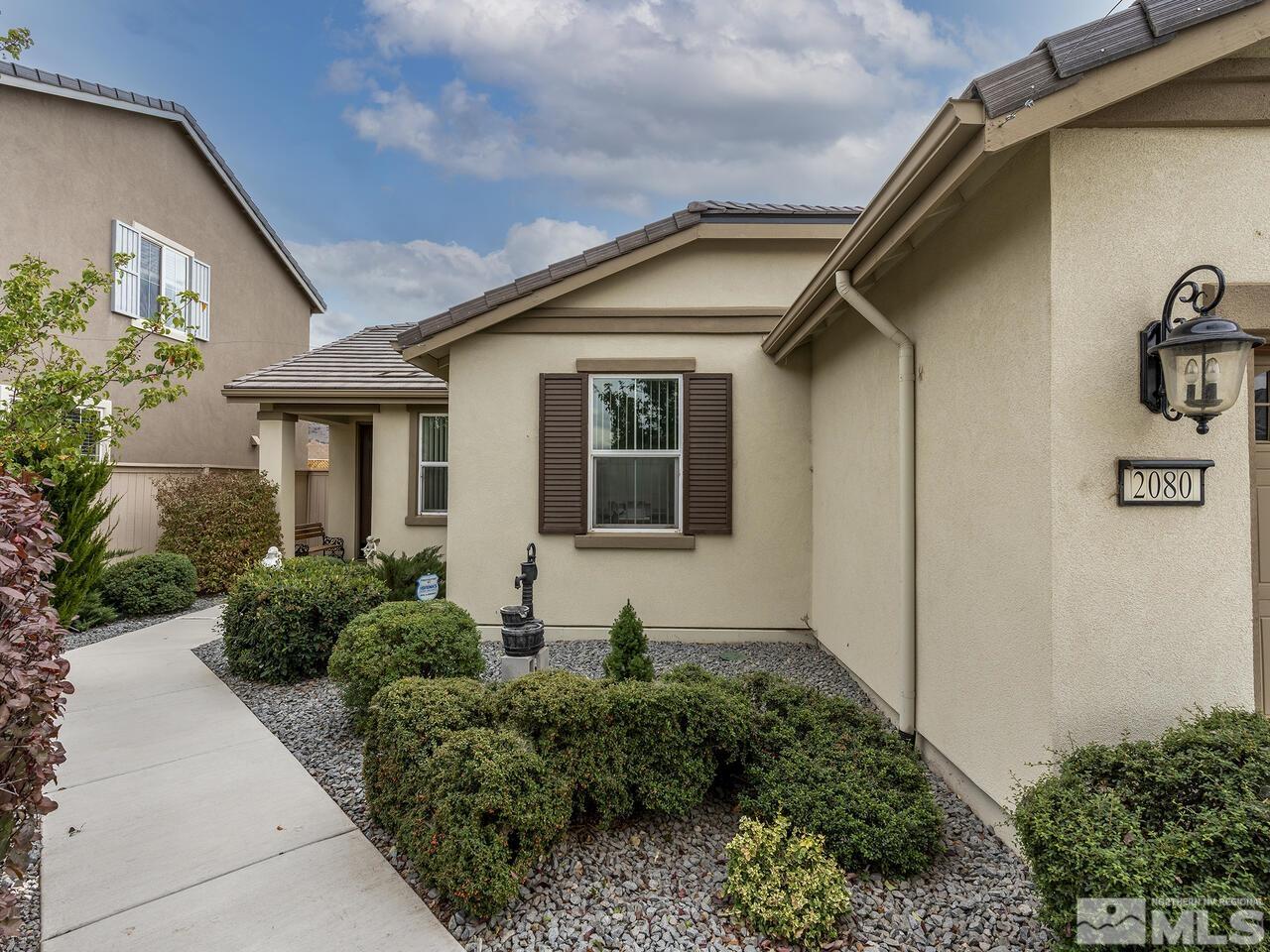 2080 Whitecliff Drive Reno, NV 89521 - Photo 2 of 21 a front view of a house with garden