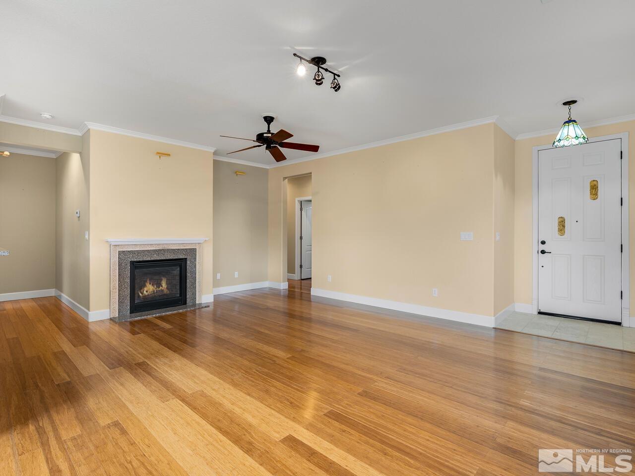 2080 Whitecliff Drive Reno, NV 89521 - Photo 4 of 21 a view of an empty room with a fireplace and a window