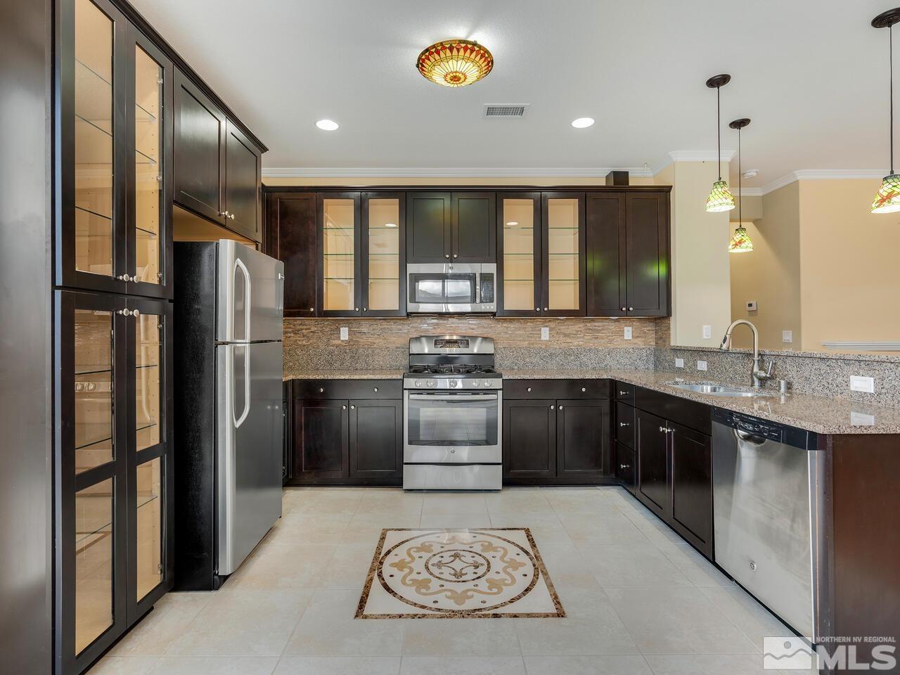 2080 Whitecliff Drive Reno, NV 89521 - Photo 7 of 21 a kitchen with stainless steel appliances granite countertop a refrigerator a stove and a sink