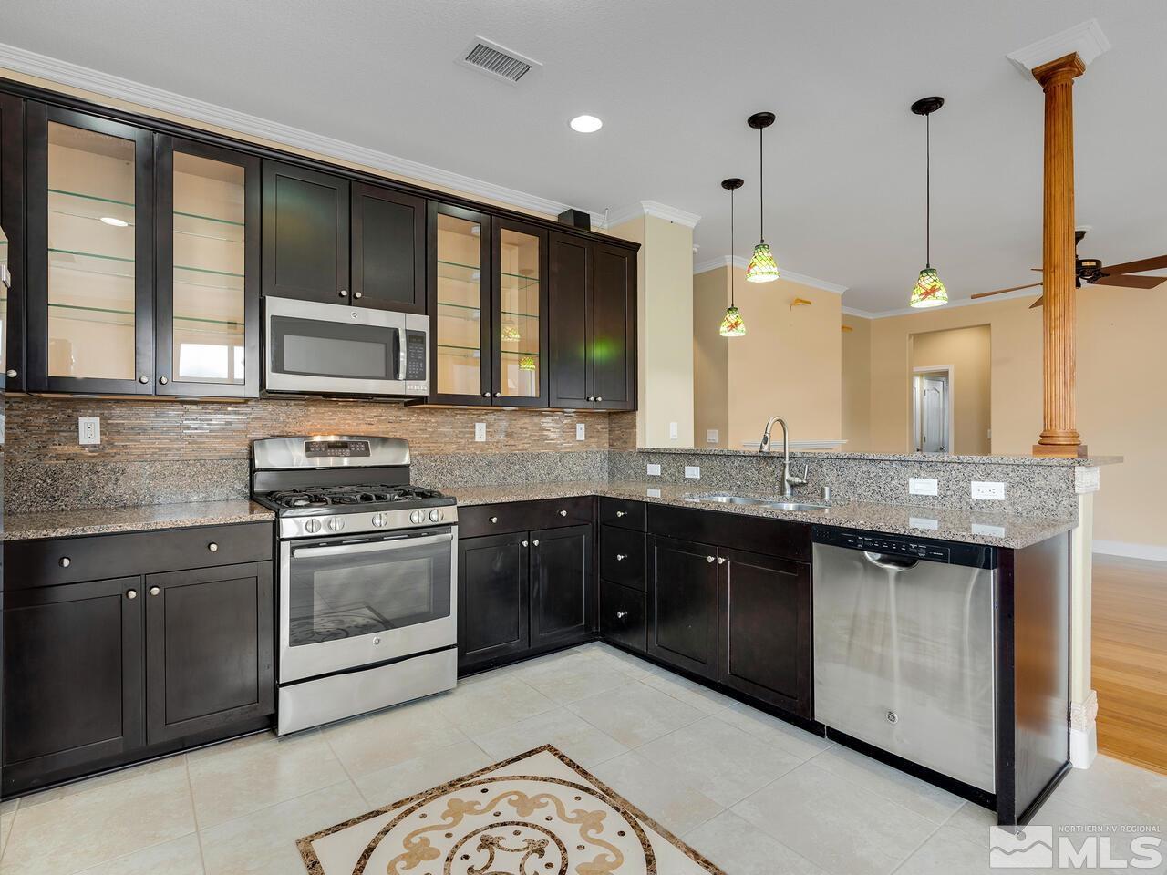 2080 Whitecliff Drive Reno, NV 89521 - Photo 8 of 21 a kitchen with stainless steel appliances granite countertop a stove a sink and a microwave