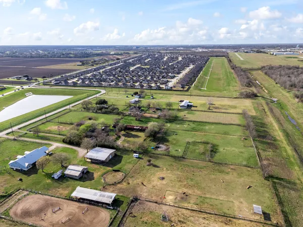 an aerial view of residential houses with outdoor space
