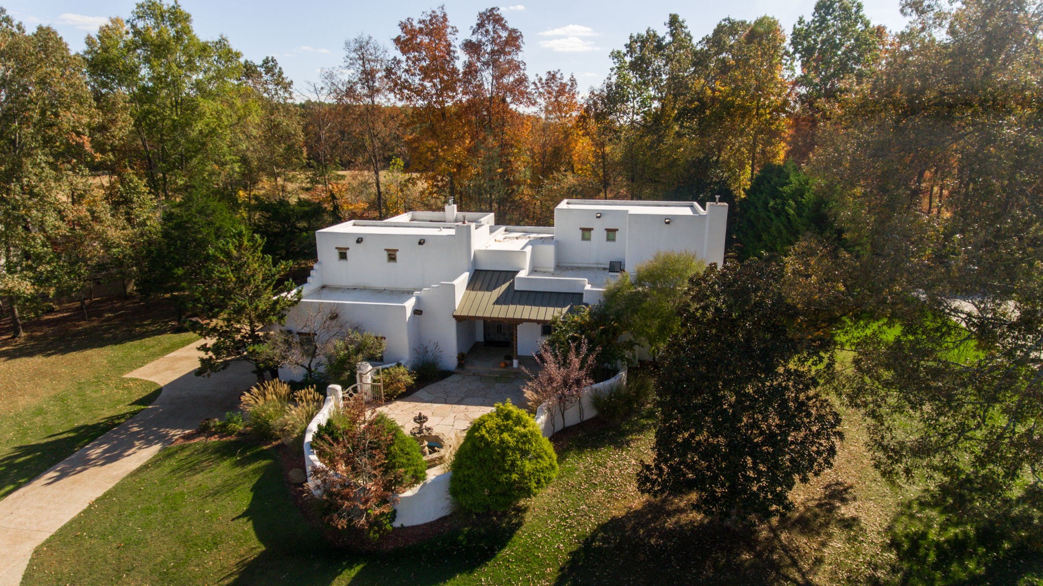 aerial view of a house with a garden and trees