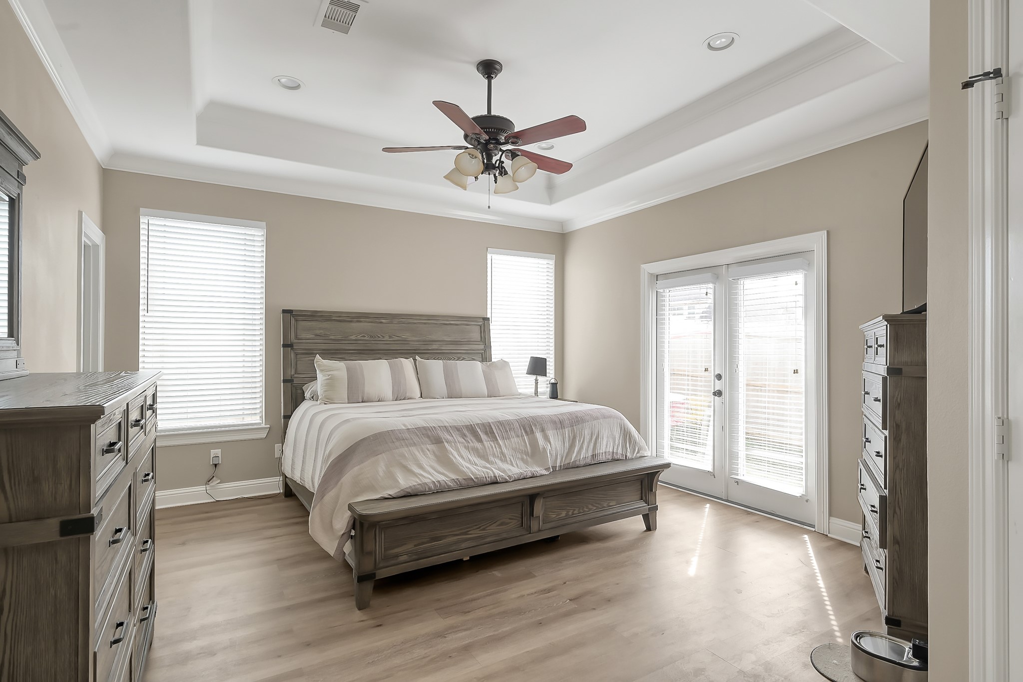 113 Capetown Way Montgomery, TX 77356 - Photo 16 of 39 a spacious bedroom with a bed and a chandelier