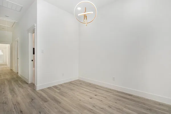 a view of a room with wooden floor and glass door