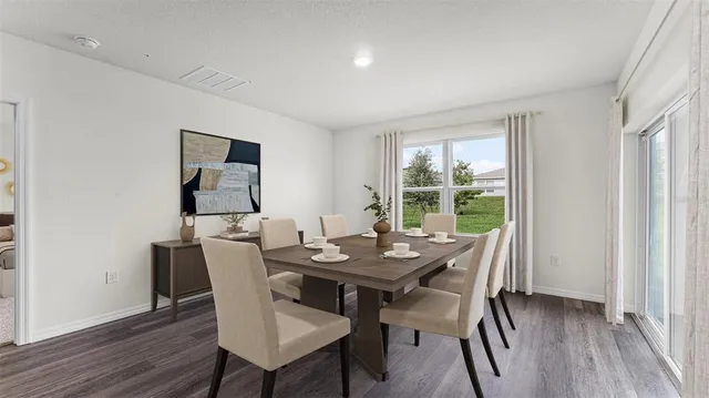 a view of a dining room with furniture window and wooden floor