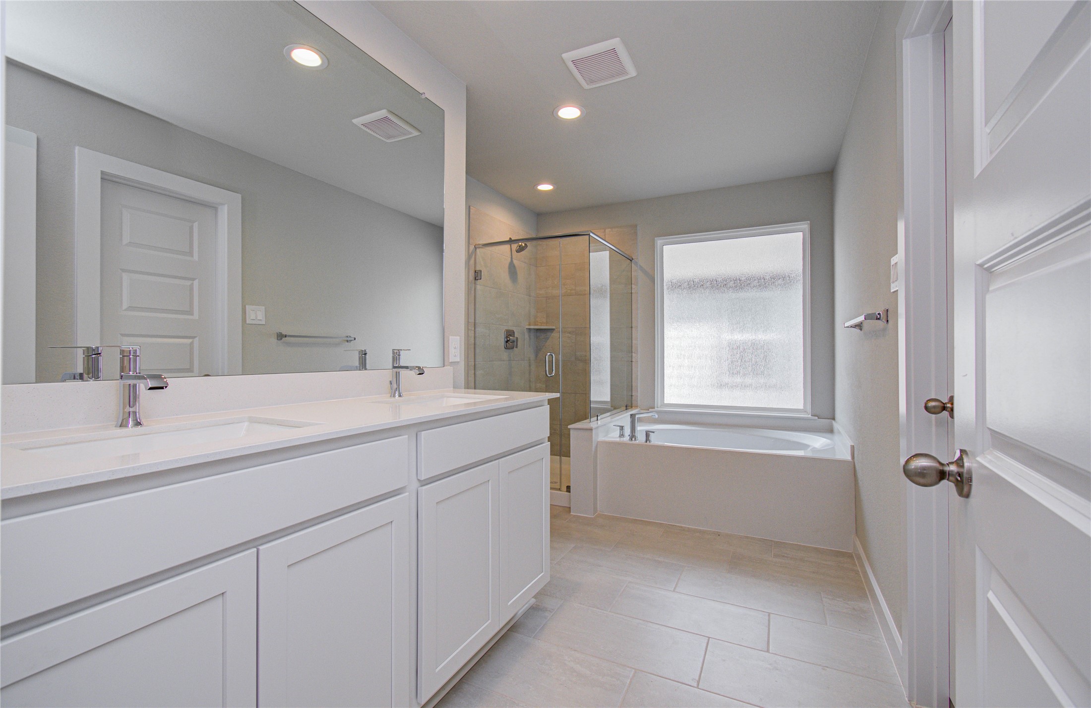 15723 Telge Ridge Lane Cypress, TX 77429 - Photo 17 of 31 a bathroom with a double vanity sink a mirror and a bathtub