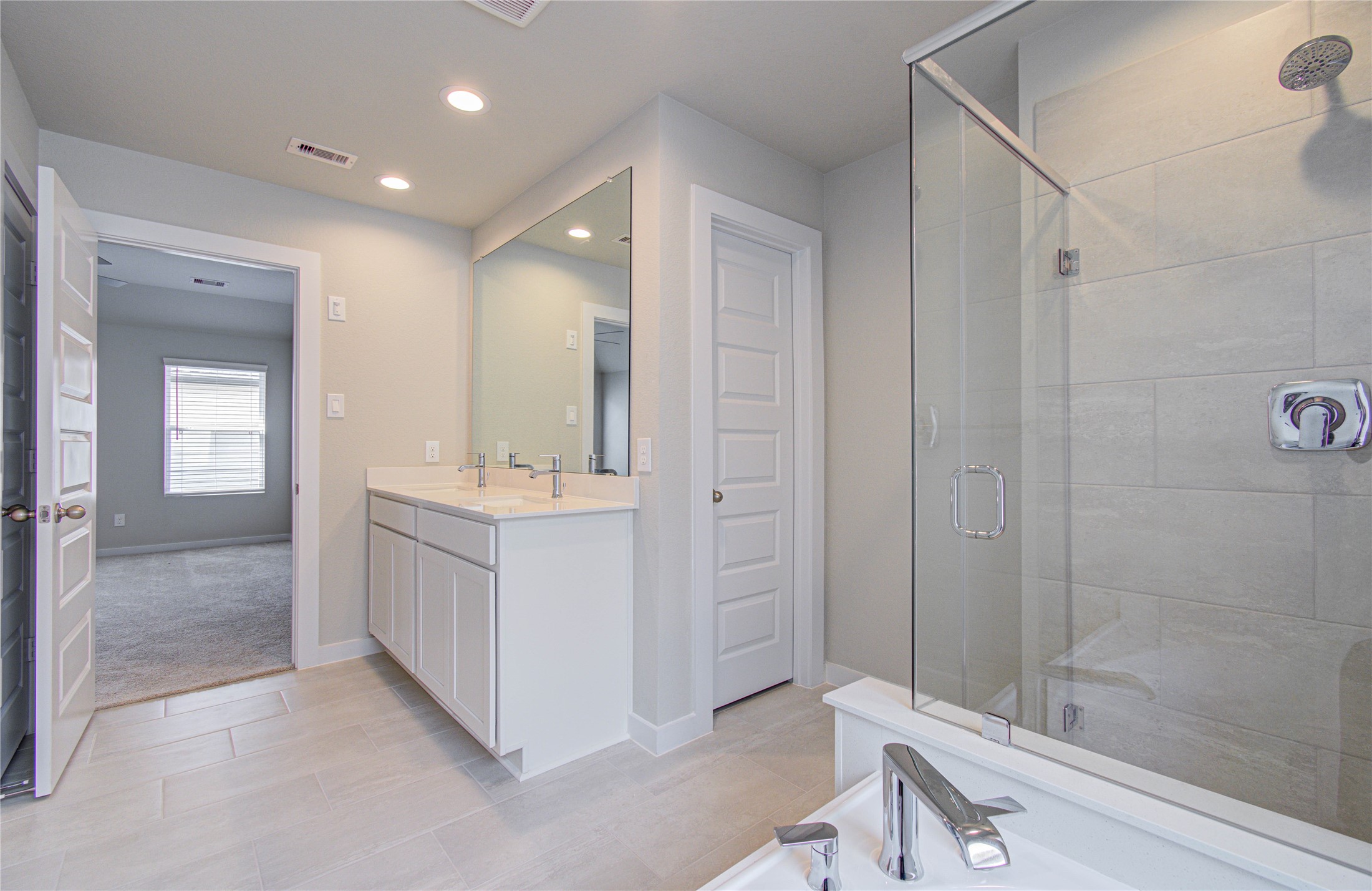 15723 Telge Ridge Lane Cypress, TX 77429 - Photo 18 of 31 a bathroom with a double vanity sink and mirror