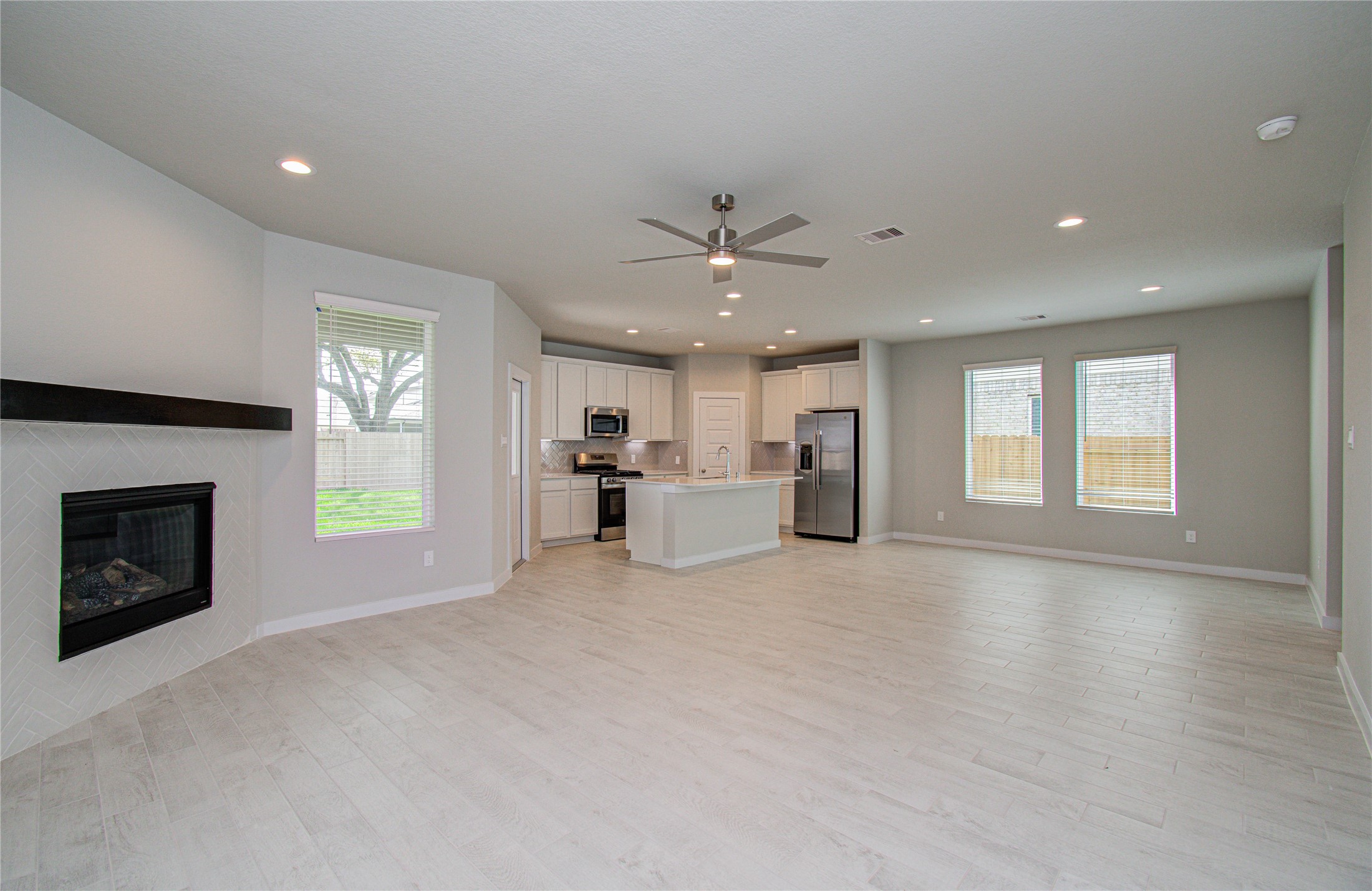 15723 Telge Ridge Lane Cypress, TX 77429 - Photo 3 of 31 a view of an empty room with a fireplace and a window