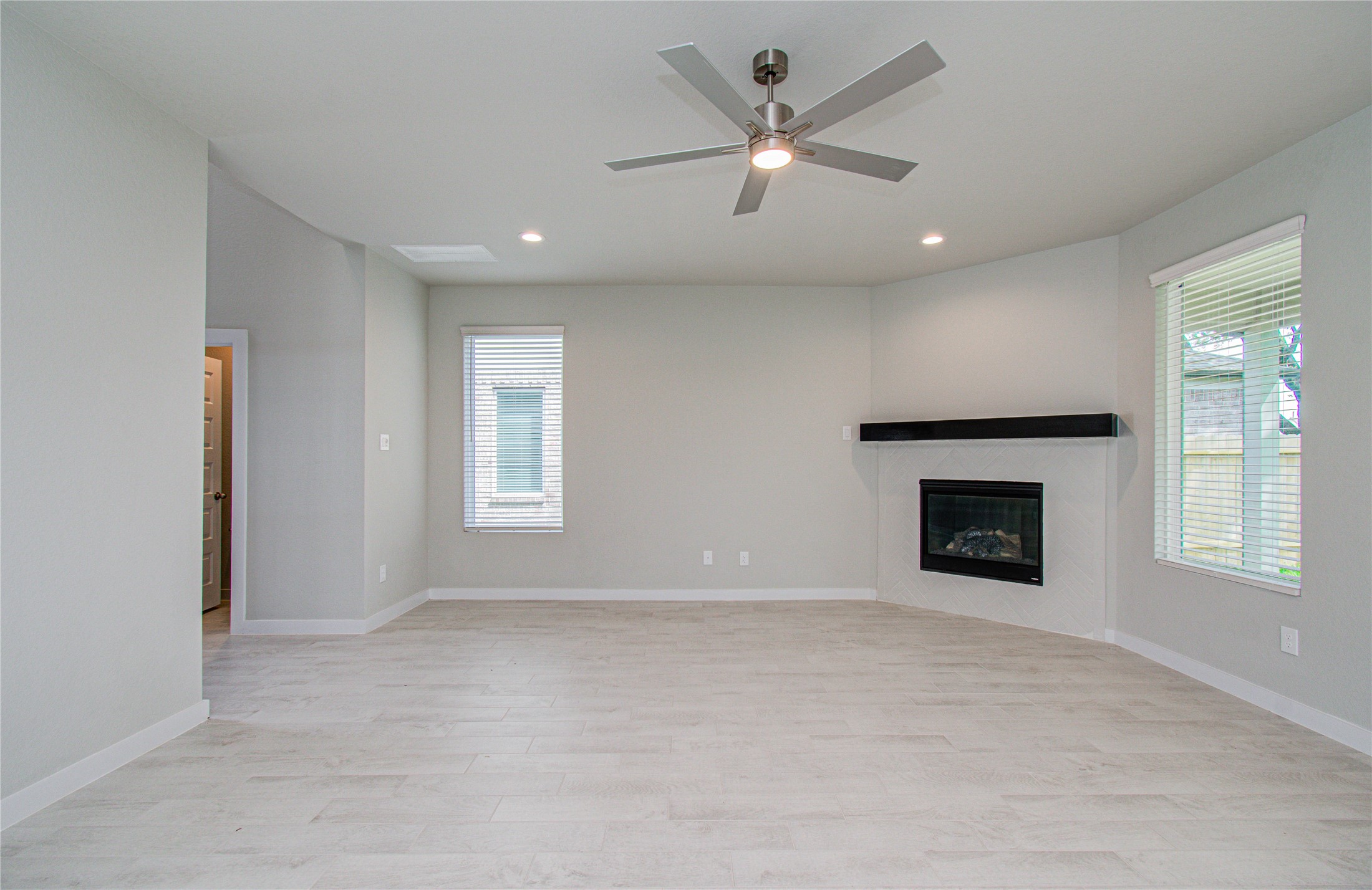15723 Telge Ridge Lane Cypress, TX 77429 - Photo 5 of 31 an empty room with windows and fireplace