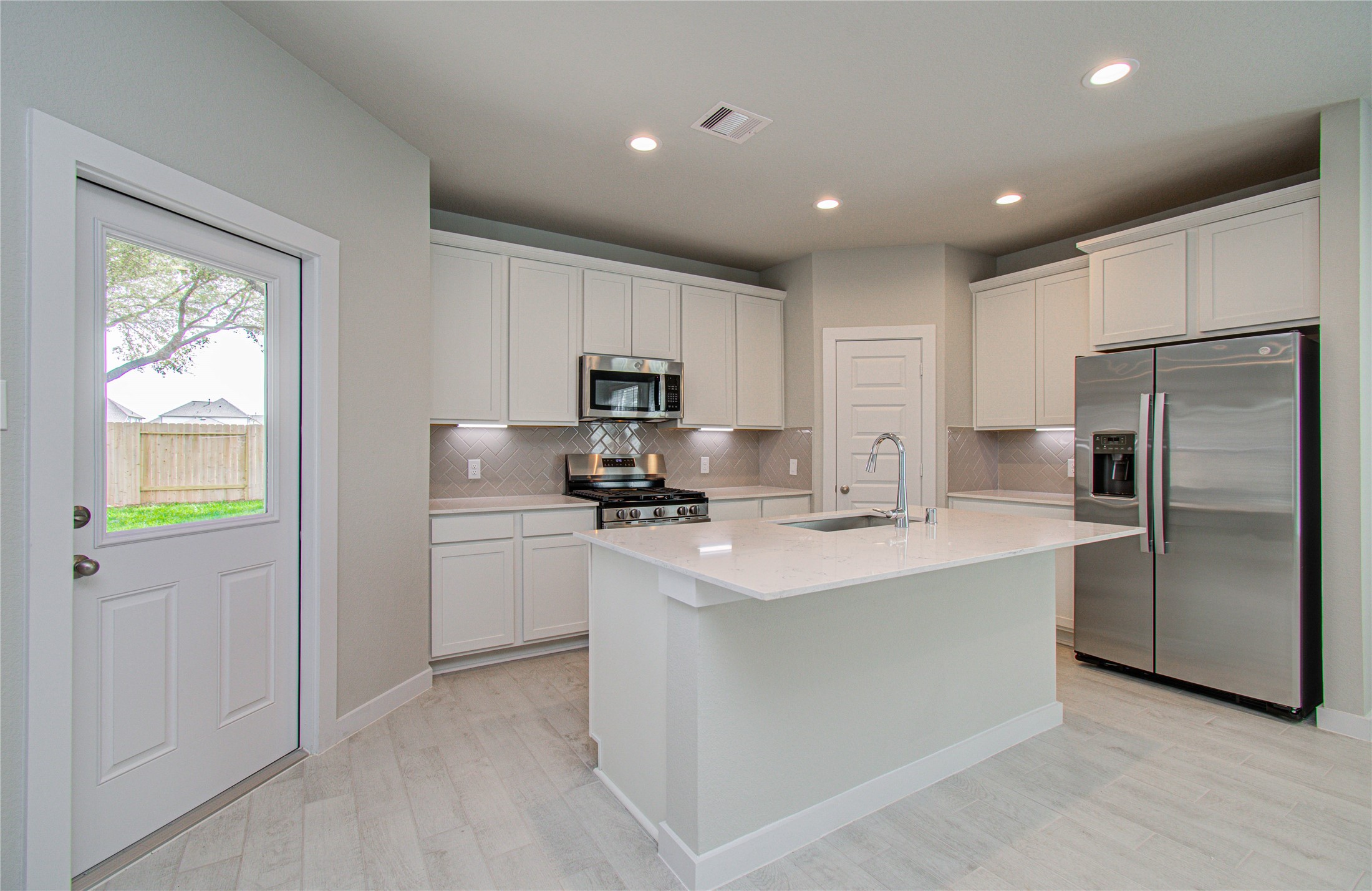 15723 Telge Ridge Lane Cypress, TX 77429 - Photo 7 of 31 a kitchen with refrigerator cabinets and wooden floor