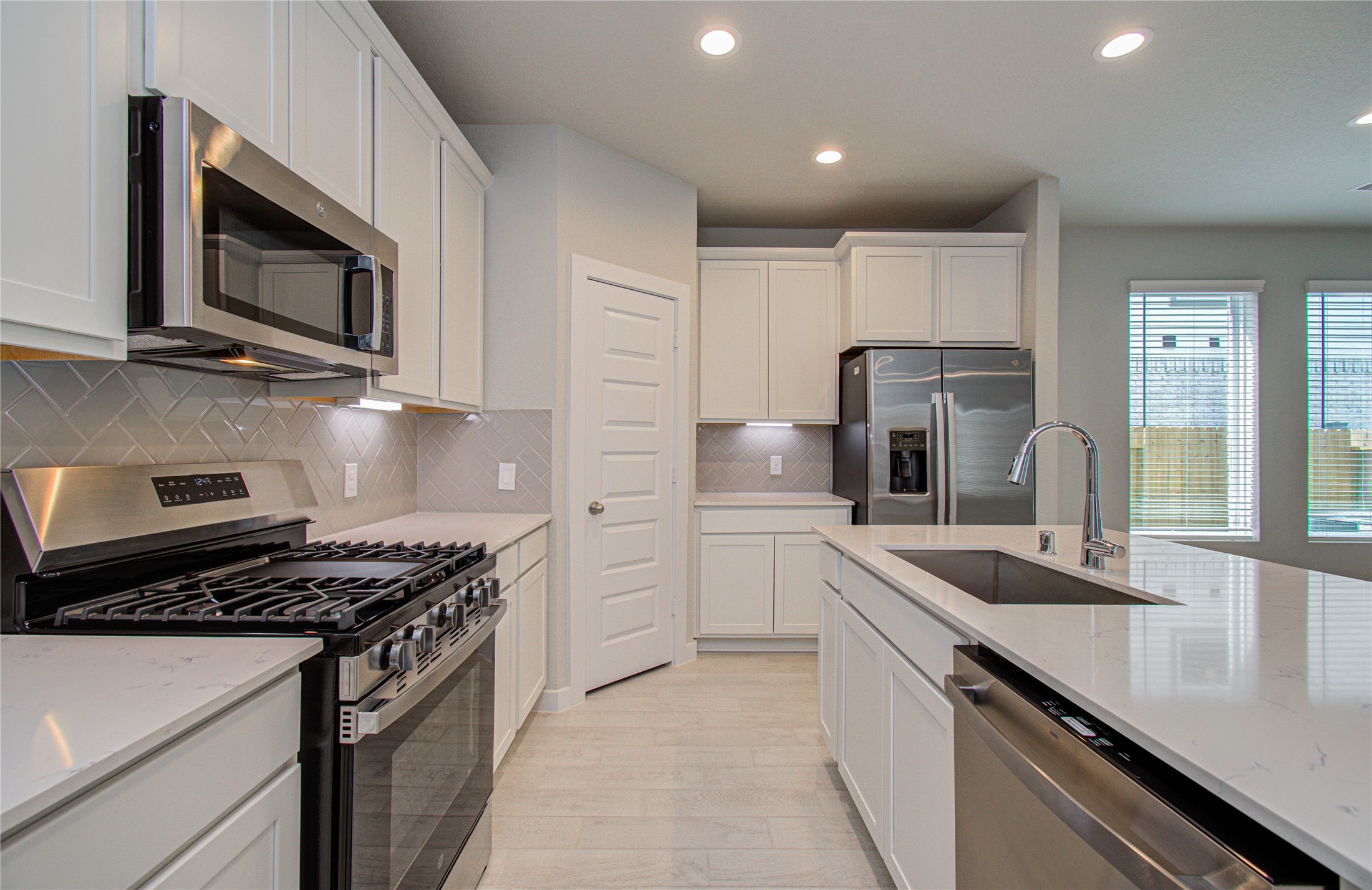 15723 Telge Ridge Lane Cypress, TX 77429 - Photo 9 of 31 a kitchen with stainless steel appliances a sink microwave and stove