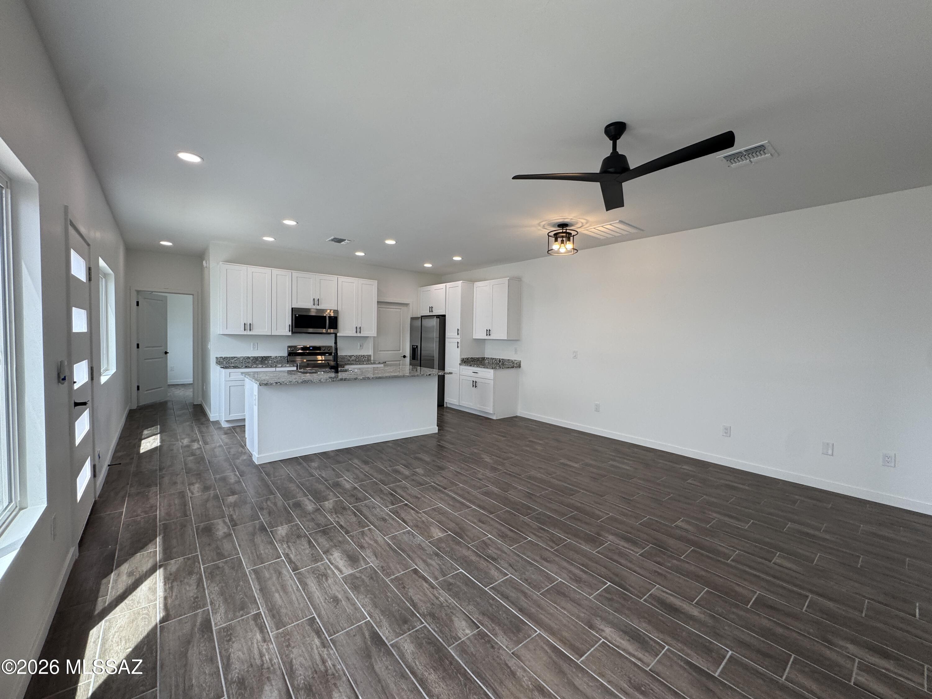 2130 North Ralph Avenue, Unit 1 Tucson, AZ 85712 - Photo 3 of 11 a view of kitchen with refrigerator microwave and stove