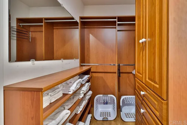 a bathroom with a granite countertop toilet sink and mirror