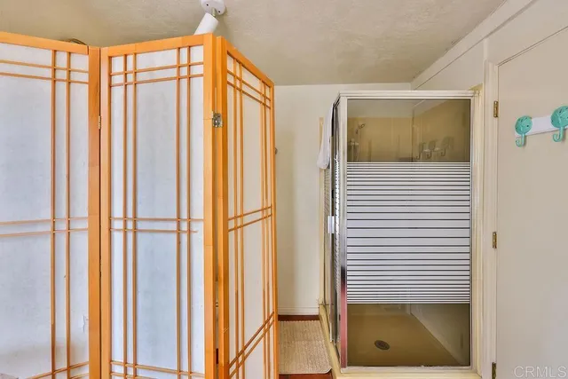 a view of balcony with chairs and umbrella