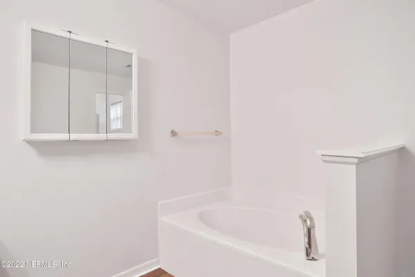 a white bath tub sitting in a bathroom