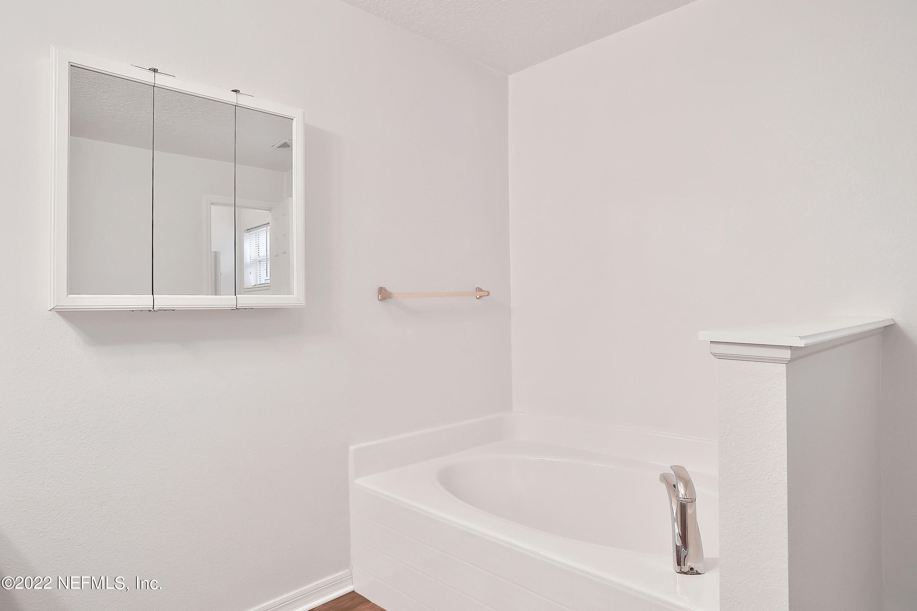 11 Wheatfield Drive Palm Coast, FL 32164 - Photo 13 of 36 a white bath tub sitting in a bathroom