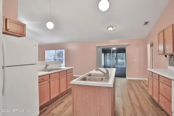 a kitchen with granite countertop a sink stove and refrigerator
