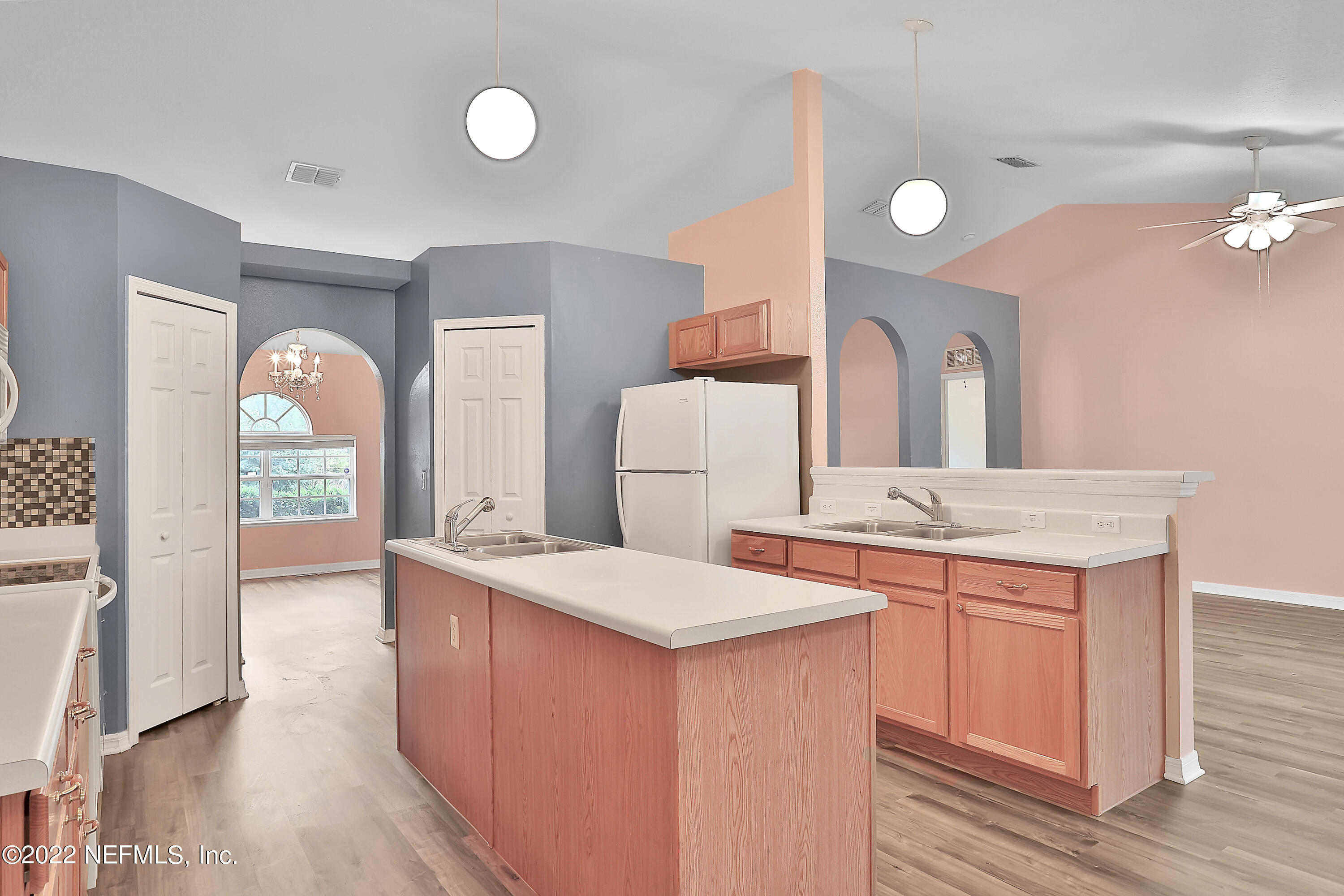 11 Wheatfield Drive Palm Coast, FL 32164 - Photo 18 of 36 a large kitchen with a sink and wooden floor