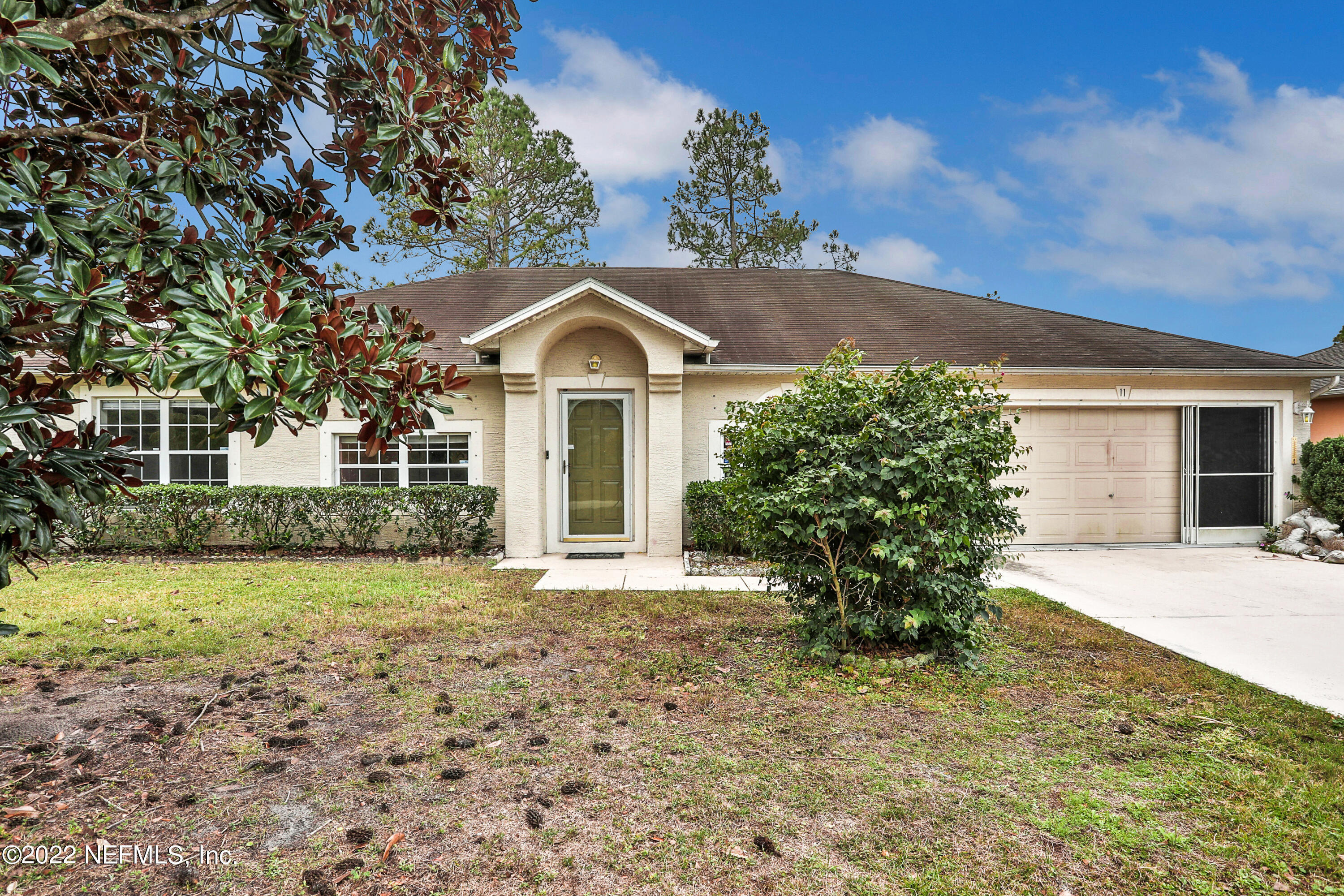 11 Wheatfield Drive Palm Coast, FL 32164 - Photo 2 of 36 front view of a house with a yard