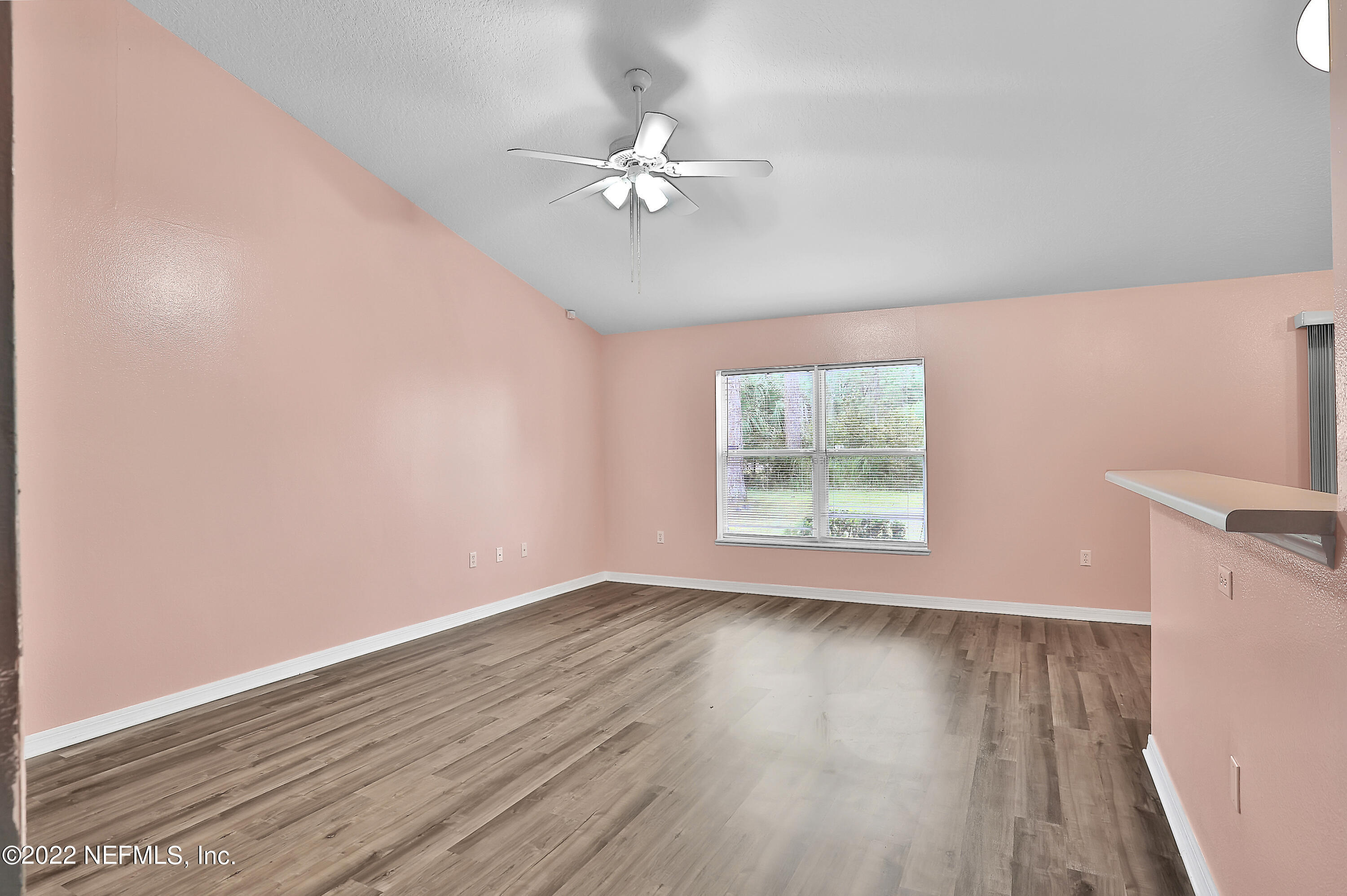 11 Wheatfield Drive Palm Coast, FL 32164 - Photo 22 of 36 a view of an empty room with wooden floor and a window