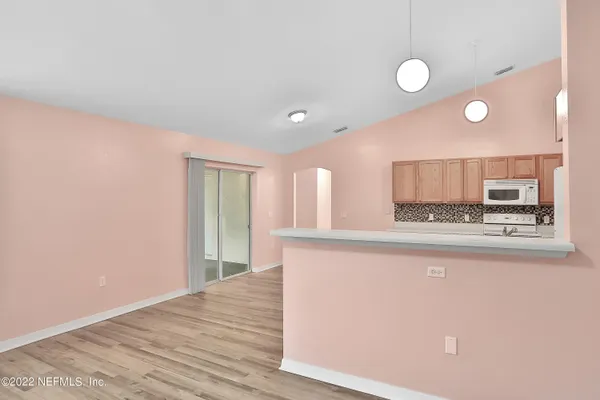 a view of kitchen with granite countertop cabinets and sink