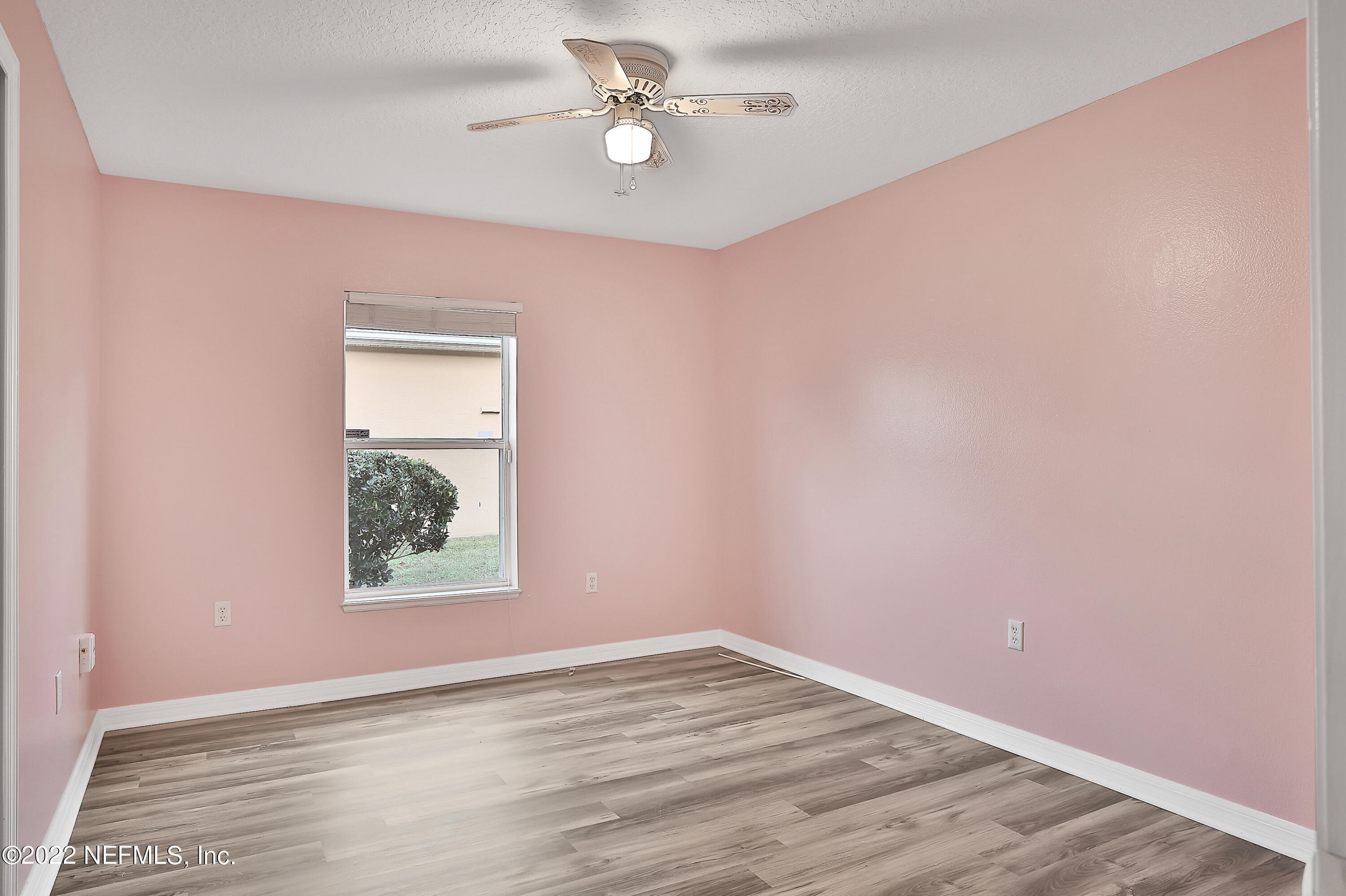 11 Wheatfield Drive Palm Coast, FL 32164 - Photo 27 of 36 an empty room with a window and a ceiling fan
