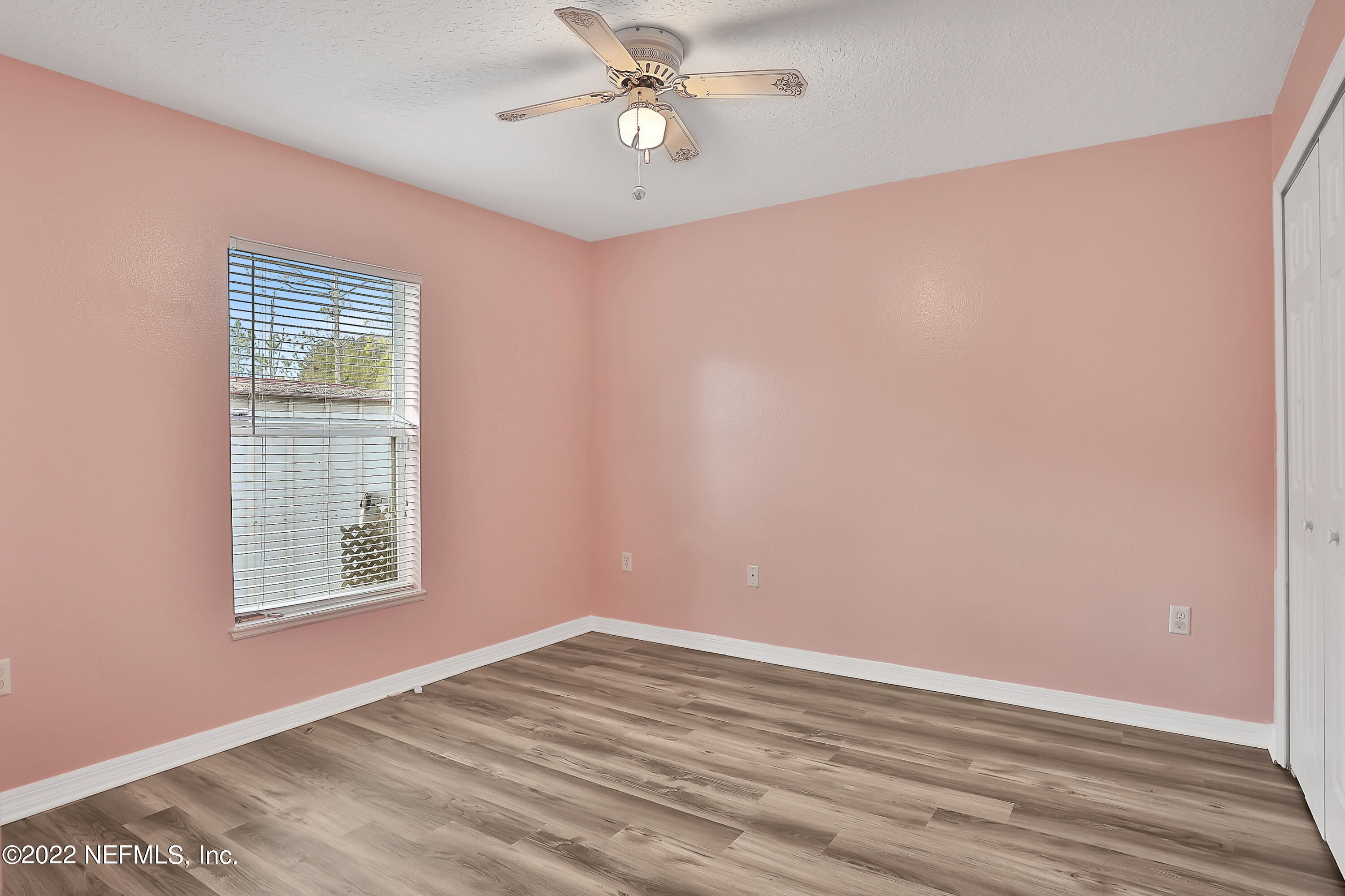 11 Wheatfield Drive Palm Coast, FL 32164 - Photo 29 of 36 an empty room with a window and a ceiling fan