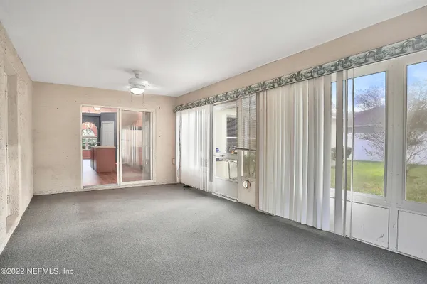 a view of a big room with windows and entryway view