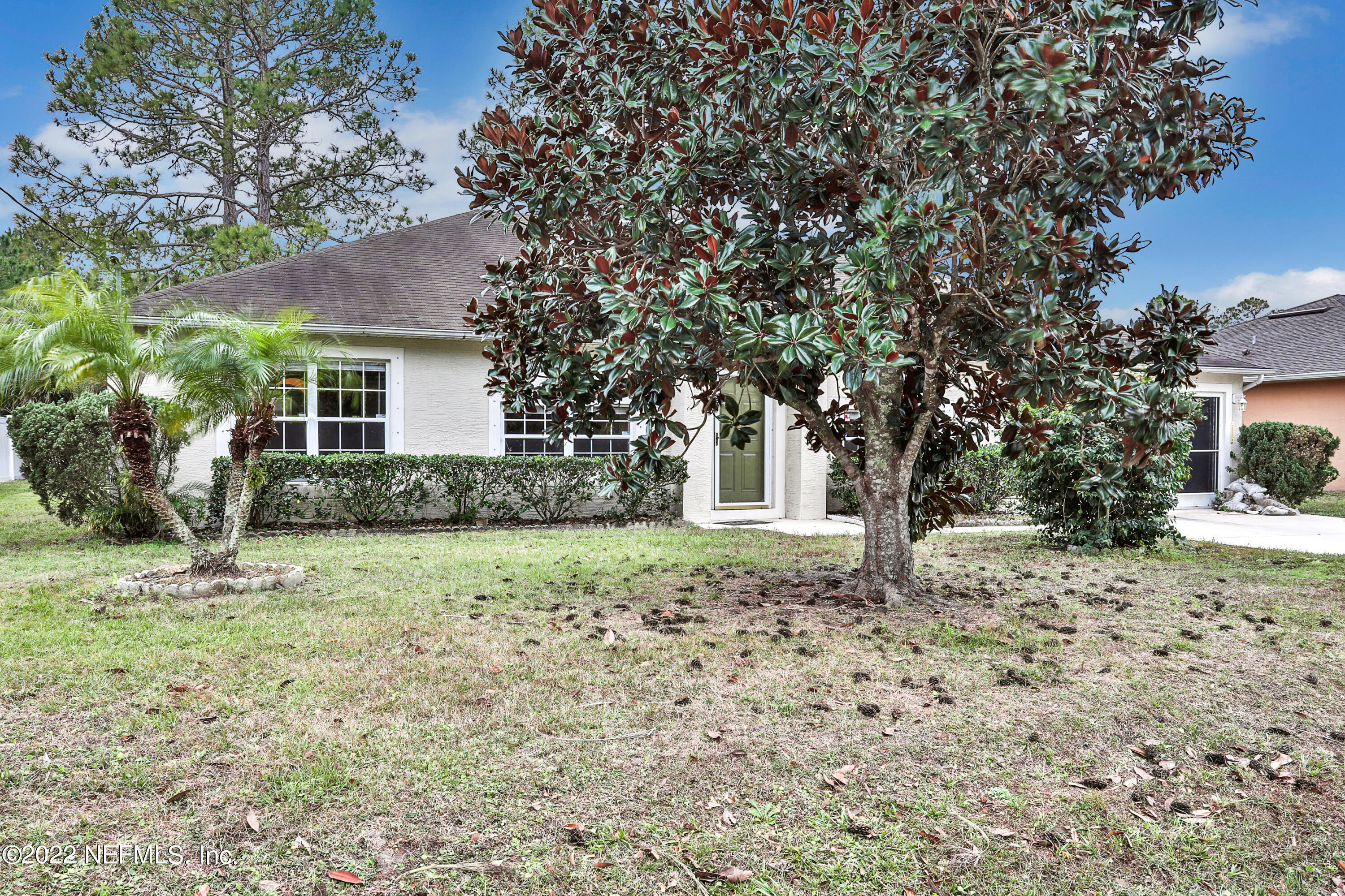 11 Wheatfield Drive Palm Coast, FL 32164 - Photo 34 of 36 a house with trees in front of it