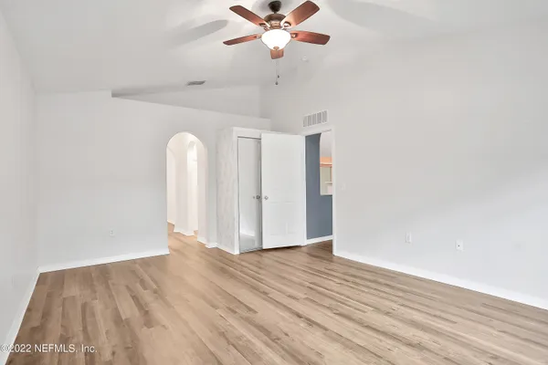 a view of a livingroom with wooden floor and a ceiling fan