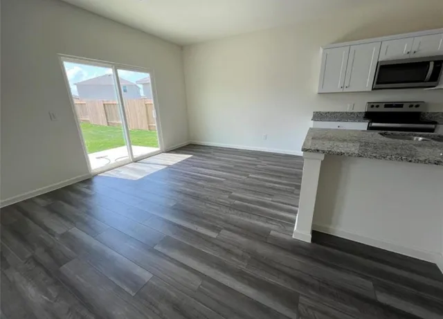 a view of a kitchen with a sink cabinets and a window