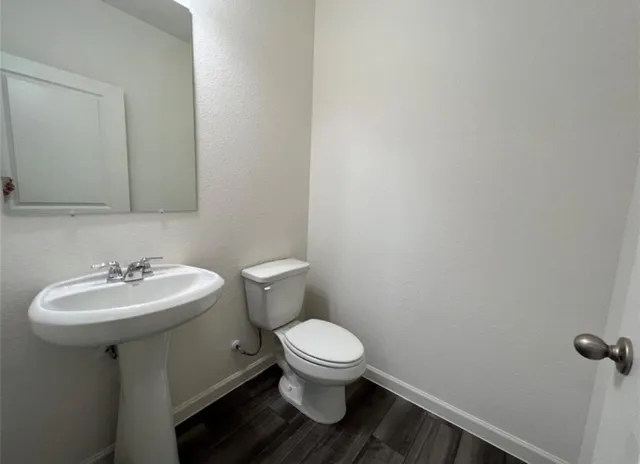 a bathroom with a sink toilet and a mirror
