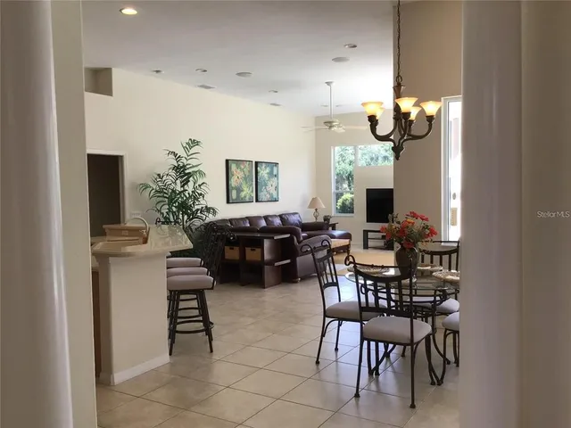 a kitchen with stainless steel appliances a refrigerator a stove a sink dishwasher and white cabinets with wooden floor