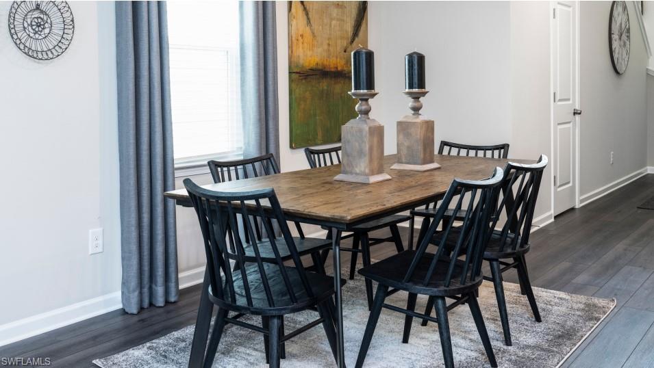 12240 Dakota Ridge Place North Fort Myers, FL 33917 - Photo 13 of 32 a view of a dining room with furniture and wooden floor