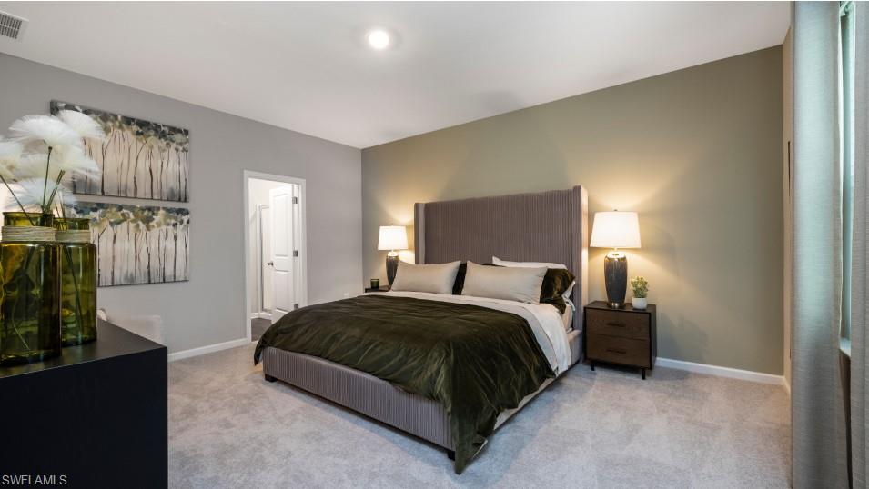 12240 Dakota Ridge Place North Fort Myers, FL 33917 - Photo 20 of 32 a spacious bedroom with a bed a couch and dresser