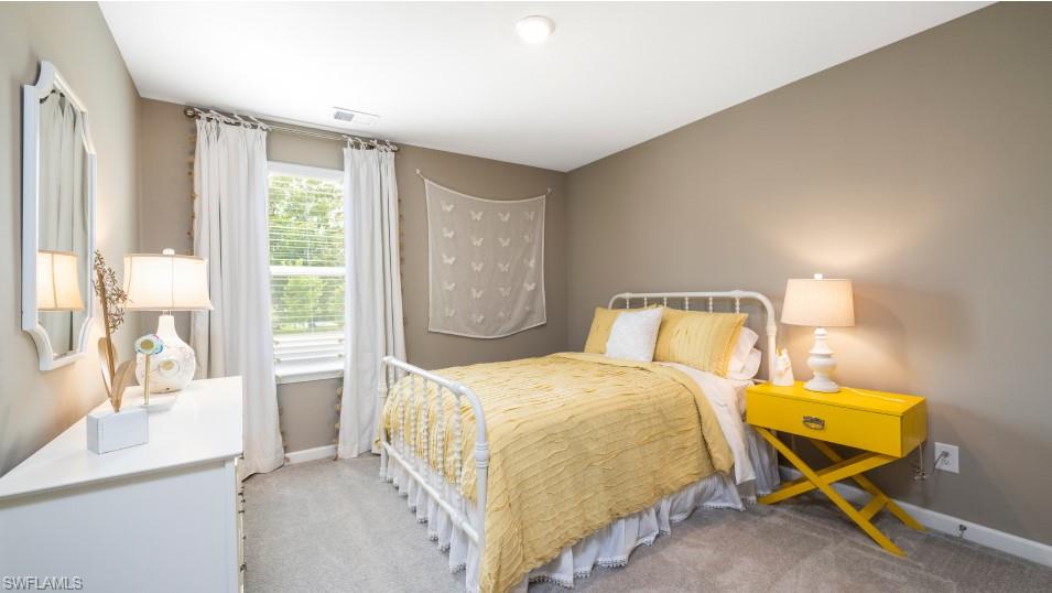 12240 Dakota Ridge Place North Fort Myers, FL 33917 - Photo 27 of 32 a bedroom with a bed and wooden floor