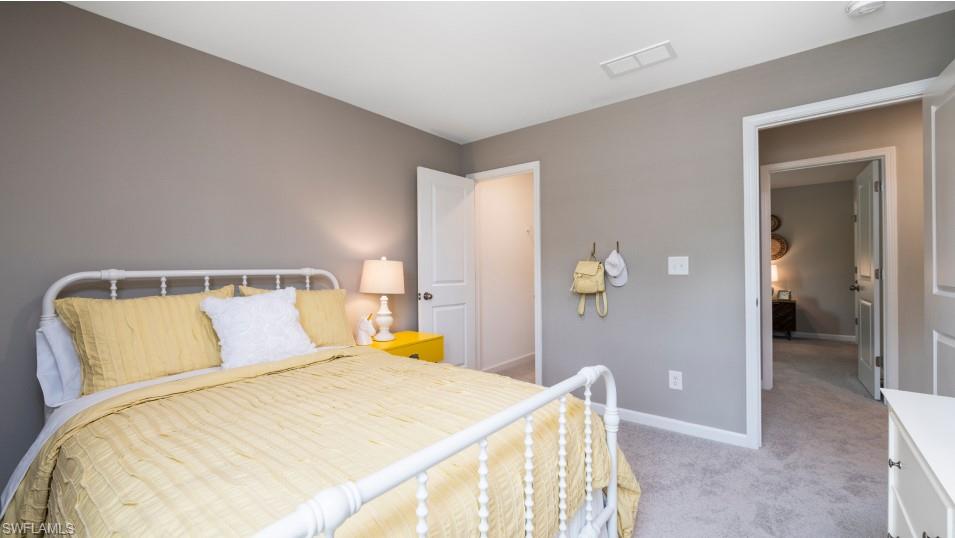 12240 Dakota Ridge Place North Fort Myers, FL 33917 - Photo 28 of 32 a bedroom with a bed and painting on the wall
