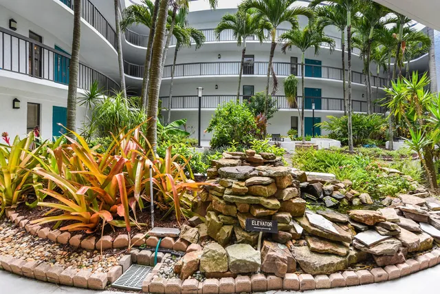 a view of a backyard with plants and outdoor seating