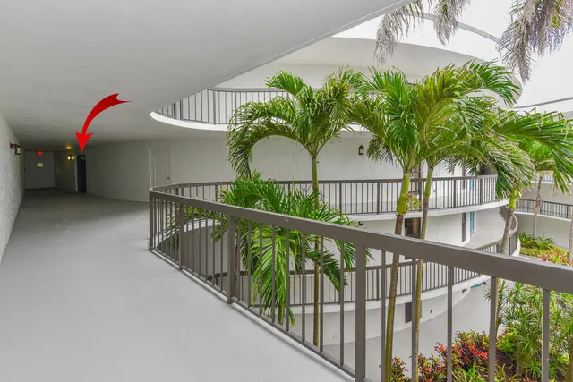 a living room with furniture and large windows
