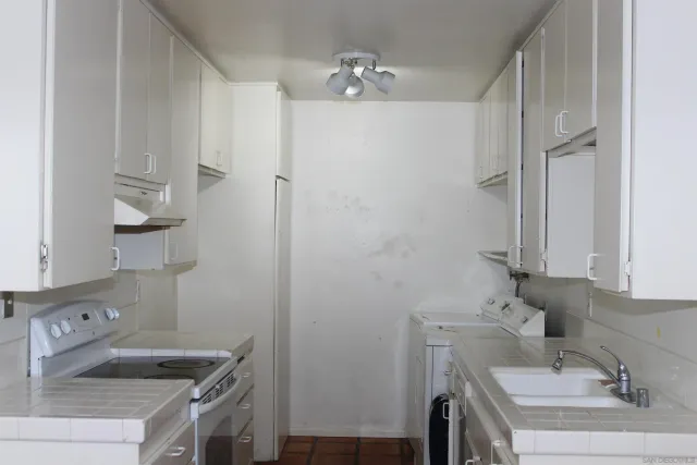 a bathroom with a sink and a washing machine