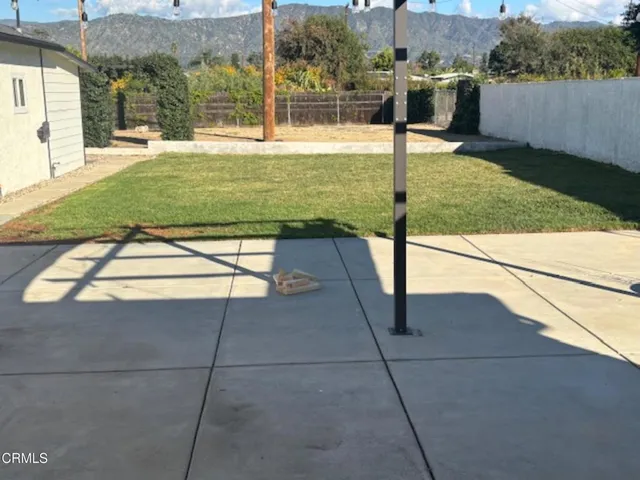 a swimming pool with yard outdoor seating and yard in the back