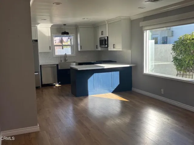 a kitchen with granite countertop a stove and a sink