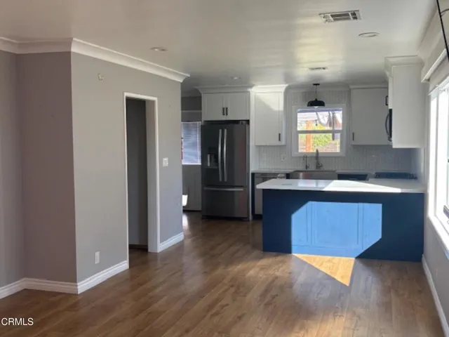 a kitchen with stainless steel appliances granite countertop a refrigerator and a sink