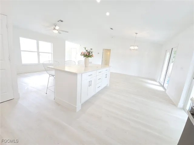 a view of a living room a window and a chandelier