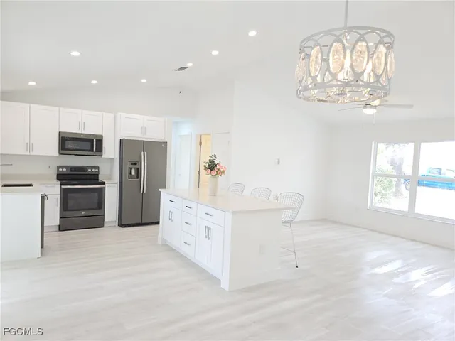 a kitchen with cabinets and stainless steel appliances
