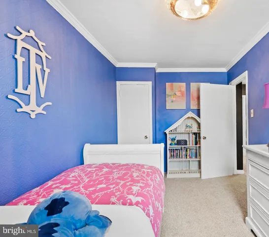 a bedroom with a bed and a dresser next to a window