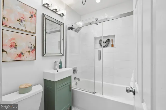 a bathroom with a shower a sink and a mirror