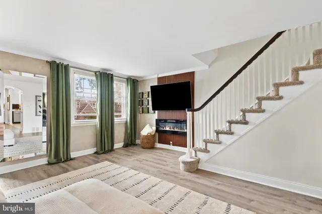 a view of entryway livingroom and hall with wooden floor
