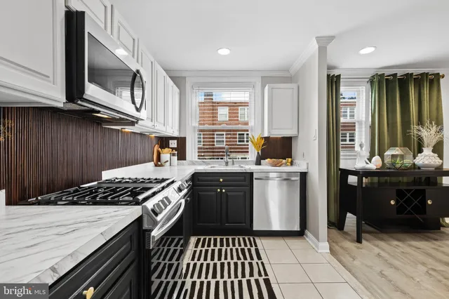 a kitchen with a stove a sink and a microwave