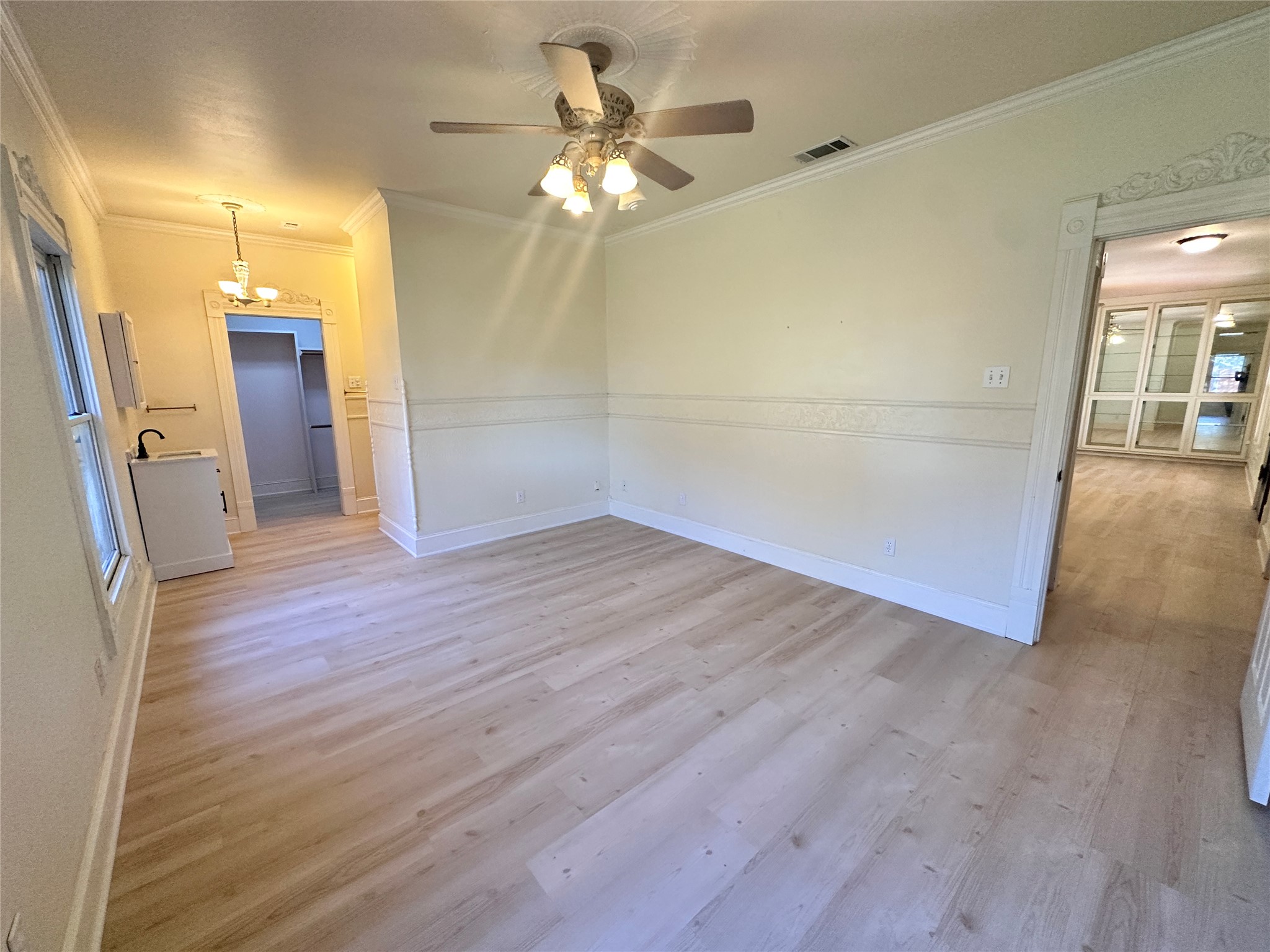 7130 Ranch 2338 Road Georgetown, TX 78633 - Photo 17 of 35 Smooth wood-style flooring and decorative crown molding frame this versatile living area.